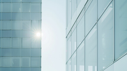 Obraz premium Modern glass facade of a high-rise building with sun glare