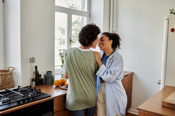 A loving couple shares a tender moment while preparing a meal at home.