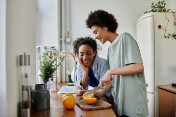 A loving couple shares smiles while preparing food in their inviting kitchen.