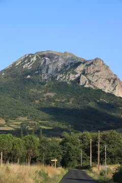 Country road leading towards Pic de Bugarach, the highest summit in the Corbieres mountain range located in Aude department, southern France