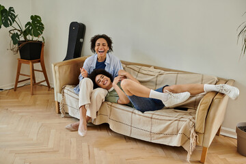 A loving couple shares laughter together on their couch in a warm, inviting setting.