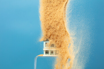 Sand storm hit House as natural disaster from climate change global warming. Strong wind of sand attack house with insurance create loss damage environment. Blue background isolated