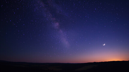 Fototapeta premium A night sky filled with stars and a glowing Milky Way, with the faint outline of a crescent moon adding to the celestial scene.