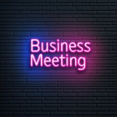 Fototapeta premium A vibrant neon sign reading 'Business Meeting' against a textured wall, perfect for corporate or event imagery.