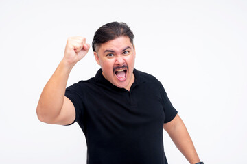 An angry middle aged man putting his fist up and yelling in protest, demanding justice and...