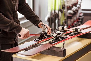 Ski Boots Binding Installation in Ski Rental Center. Master Fixing Ski Binding. Ski Service for Ski...