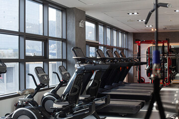 Fototapeta premium Gym Room Fitness Center With Equipment And Machines