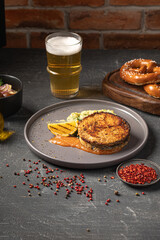 Portion of gourmet grilled salmon steak with beer and pretzels