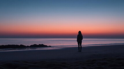 Person standing on a beach at dawn, ready to begin a new day
