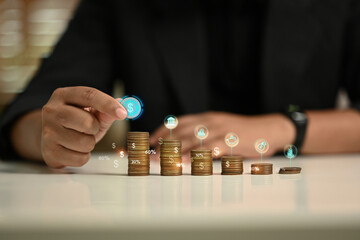 Businessman stacking coins in ascending order representing financial growth and savings goals