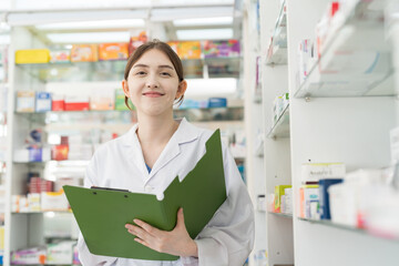 Pharmacist woman checking list of medicine in drugs shop pharmacy