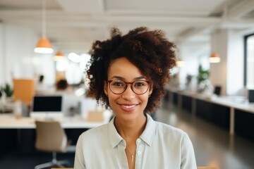 Fototapeta premium Smiling portrait of a young hipster woman in office