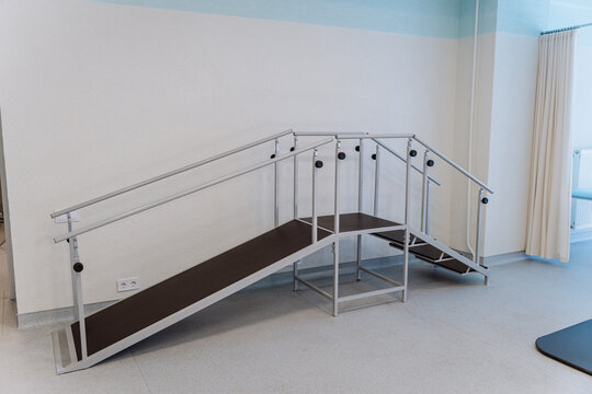 Rehabilitation room with parallel bars and equipment for physical therapy and mobility training