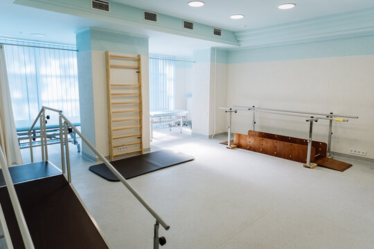 Rehabilitation room with parallel bars and equipment for physical therapy and mobility training