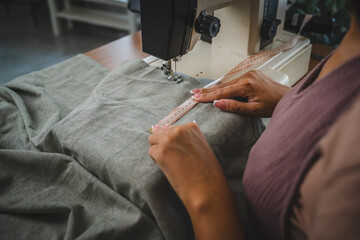 Close up of unknown woman hands work with measuring tape