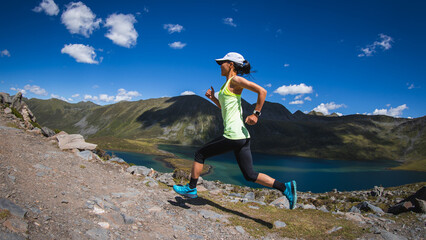 Fitness woman runner running at beautiful mountain top