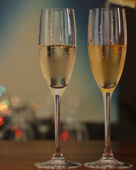Image of a bar counter pouring alcohol into illuminated champagne glasses