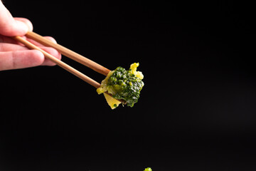 Broccoli on a white plate on a black background.food concept.diet.