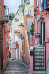 Picturesque Italian alley in pink colours on the island Procida.