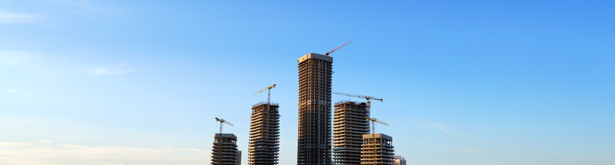 Skyscraper Construction. Tower Crane on formworks on construction site. Construction crane on Housing. Construction of Multi Storey Residential Building. Skyscraper built. Tower Cranes on building.