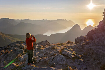 Fototapeta premium Children and adults, family with dog, hiking Grytetippen trail in Senja, Lofoten on a sunny hot summer day