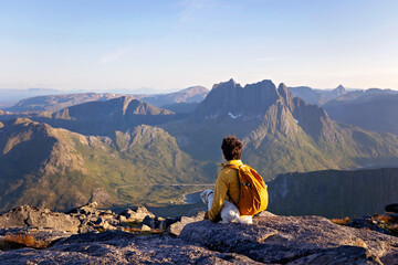 Children and adults, family with dog, hiking Grytetippen trail in Senja, Lofoten on a sunny hot summer day