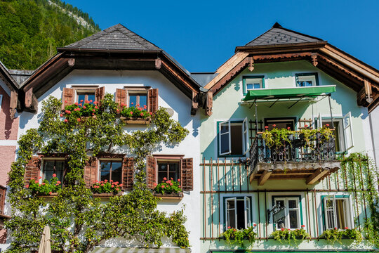 Charming architecture of Hallstatt Austria adorned with vibrant flowers on a sunny day