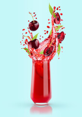 Red cherry juice in drinking glass with flying cherry pieces, green leaves, splashes on blue ...