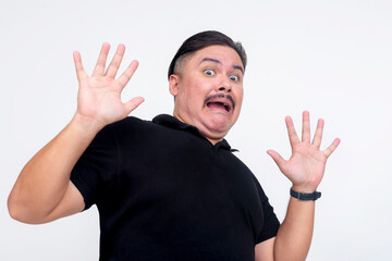 Fototapeta premium A middle aged man gets spooked, reacting hilariously. A antsy guy who can easily be scared. Isolated on a white background.