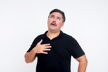 A middle aged man clutches his chest feeling pressure and congestion while feeling dizzy, symptoms...