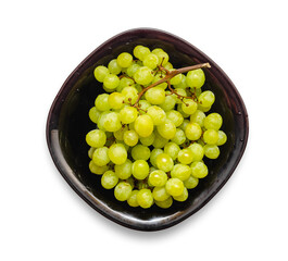 Bunch of juicy white grapes on a black plate. isolated on white. Vitamins for health, vegan food.