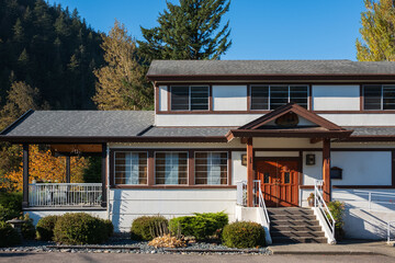 Country house in North America. Wooden house in green forest. wooden country house or cottage with trees around.