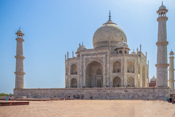 Image of the Taj Mahal in Agra, India, under a clear blue sky. The white marble mausoleum features a grand dome, minarets, and intricate carvings, symbolizing love and Mughal architectural splendor.