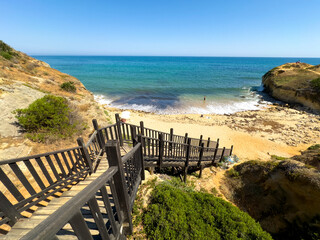 Beach access with wooden stairs to one of many Portuguese beaches, Algarve region.