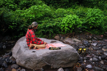A Muslim traveler praying on big rock in Indonesia. Islamic and Ramadan background