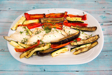 Sea bream fillet with vegetables  eggplants and peppers typical dish of the Mediterranean diet in Italy
