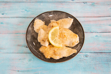 scaloppine al limone is a typical dish of the traditional cuisine of Rome and Lazio in Italy made with veal breaded in flour and cooked with lemon