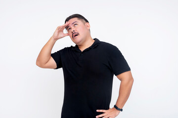 A middle aged man feeling dizzy and disoriented. Touching his forehead. Isolated on a white...