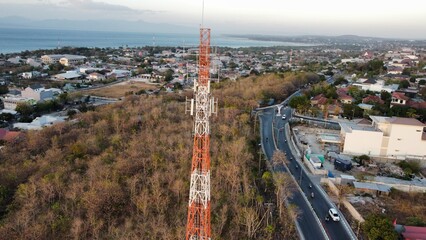 Drone wide view of a cellular transmitter next to the road