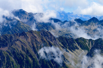 Mountain peaks iand clouds n the French Pyrenees near Pic du Midi de Biggore, Haute-Garonne, France, high mounain view in sunny day