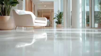 This image showcases a bright and spacious modern lobby with a stylish white sofa and lush green plants, creating a minimalist and inviting atmosphere.