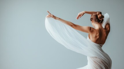 Fototapeta premium This image illustrates a graceful dancer wearing an ethereal white fabric, striking a pose, symbolizing freedom and artistic expression within a minimalist setting.