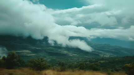 Fototapeta premium A serene landscape with clouds drifting over a mountain range AI generated illustration