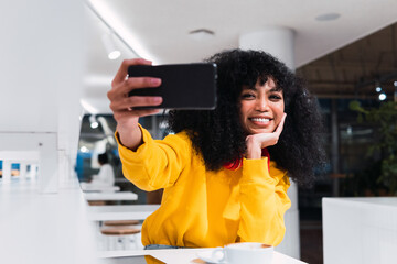 Teen taking selfie or photo in a bar