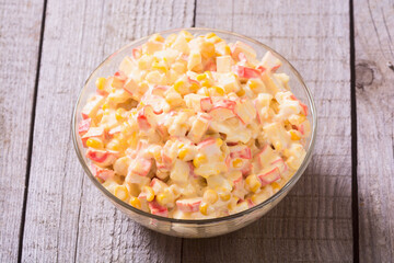 Traditional Russian New Year salad with crab sticks , corn , eggs and mayonnaise
