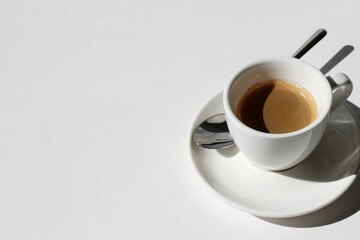 Freshly Made Espresso with Crema Foam on White Background. Cafe.
