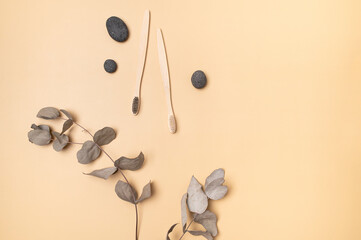 Natural eco wooden bamboo toothbrushes and natural stones on beige background. Dental care,...