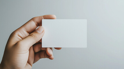 Fototapeta premium hand holding an empty white business card, set against a transparent background. This mockup is ideal for corporate business advertising and branding presentations, offering flexib