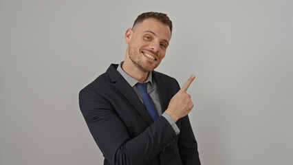 Smiling businessman pointing side isolated against a white background