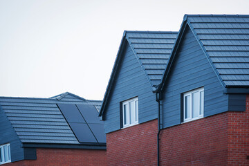 Photovoltaic solar panels on the roof of new built house in england uk. The concept of a sustainable environment, construction.